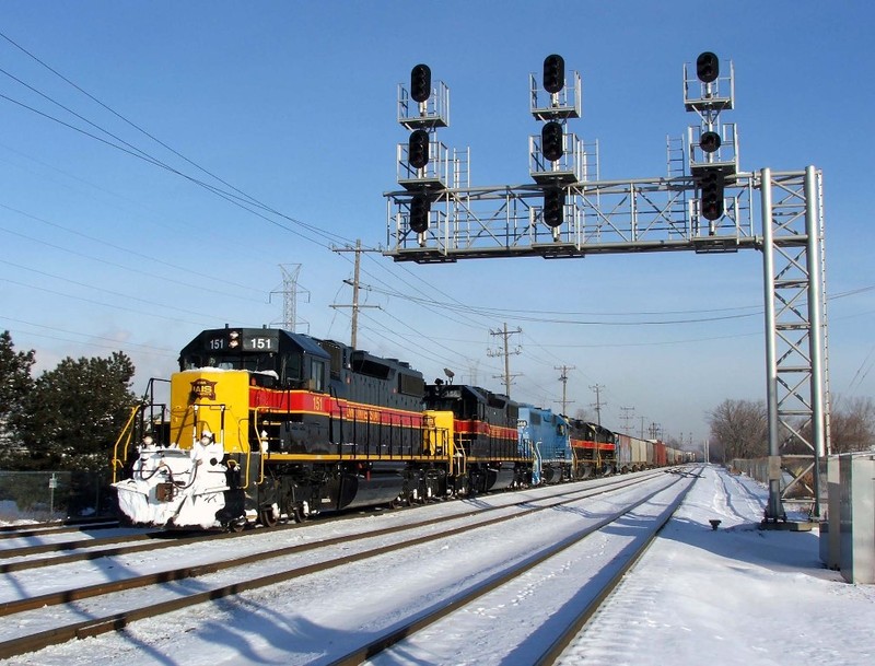 Another view of 151 as the engineer takes a couple notches under the large modern cantilever signal bridge. The train was so long that it just cleared McCook Inter. now.