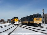 A CSX geometry test car passes the detour train right on the diamonds. The CSXT owns part of the Harbor and does a bit of the maintenance.