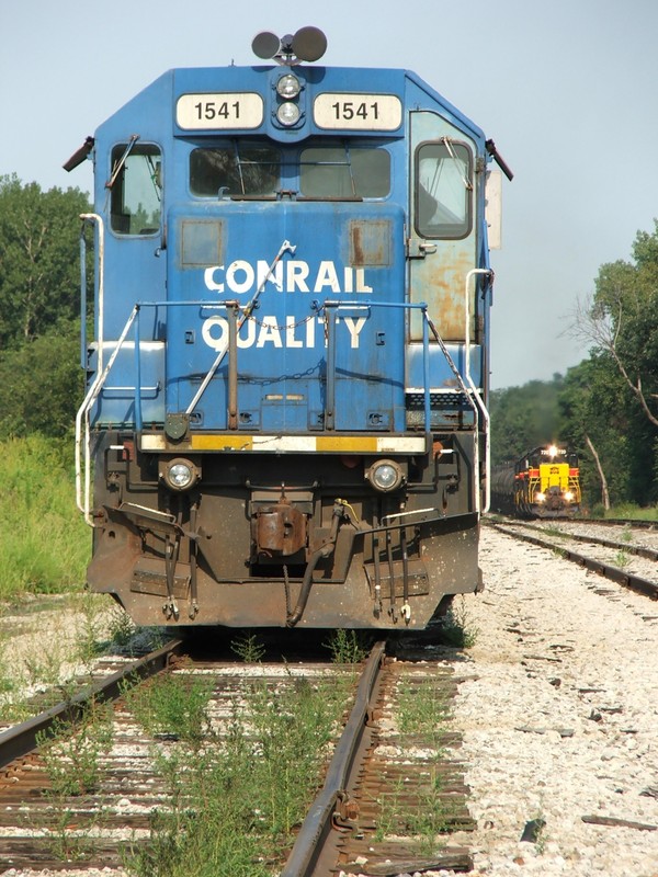 Iowa 720 heads into Marseilles and is about to pass some CSX local power comprised of a former Conrail GP15-1.