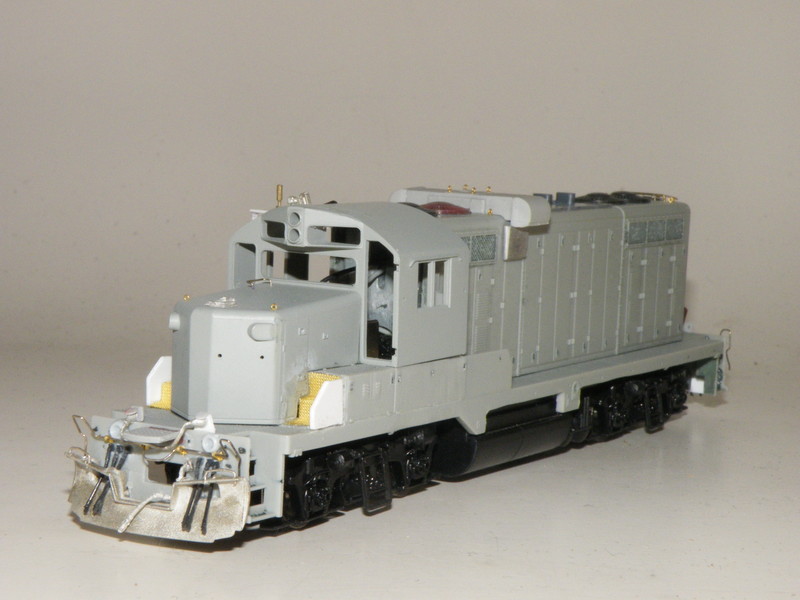 My HO scale 400 started out as a Proto 2000 PRR GP7 I stripped. I filed away the side skirt to match the prototype and chopped out the front battery box on either side. I filled in the gaping holes with steps I just made from stock tread and added styrene pieces where the front battery boxes used to be. 400 prototypically has a GP20 cab and short hood, which I picked up from fellow modeler Joe Atkinson. It was not a hard fit at all and once the model was glued together, I added all the basic details: Kato air hoses, and various details west and details associates parts. I also made the fire cracker antenna stand out of styrene. I fairly basic straight forward model, the only thing missing at this time were doors. But I am now in the middle of decaling and detail painting the nearly completed unit.