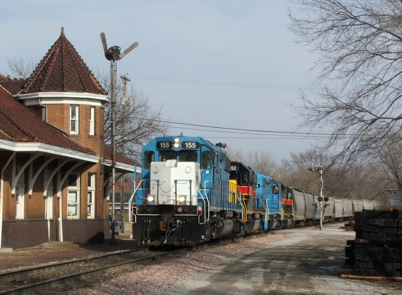 ICCR with IAIS 155, 152, 154, and 150 departs Iowa City passing the restored RI depot at the west end of town.
