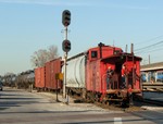 Iowa's only cupola caboose heads west into the sunlight leading BISW out of Burr Oak Yd. 04-16-07