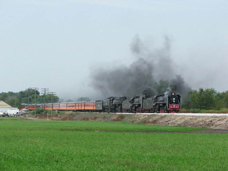 The triple header thunders out of Mineral as all three steamers whistle in unison.