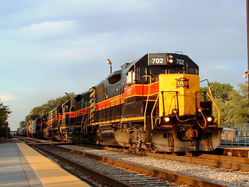 702 leads 4 others on a late BICB... the sun is about to hit the horizen at Midlothian as the train scoots through town. 08-05