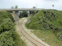 Interstate 35/80 and Highway 141 cross over the Grimes Line. To avoid the "bridge to nowhere" look common on a lot of layouts the fascia rises up to the top of the highway embankments.