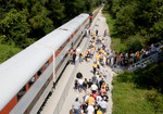 Hawkeye fans step off the Hawkeye Express and head up to Kinnick Stadium.  University Heights, IA on 02-Sept-2006.