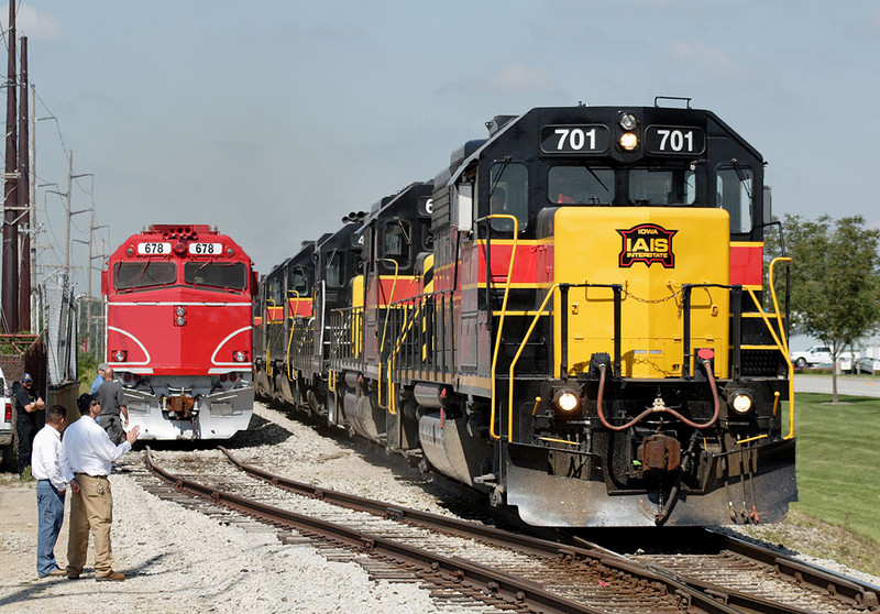 IAIS 701 on CBBI passes the Hawkeye Express stored in Vernon siding during the game.  Coralville, IA on 02-Sept-2006.