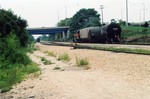 Peoria Rocket (eng 707) arrives at the north end of Limit yard, Aug. 26, 2005, under the McLuggage Bridge.  On the left are 27 empties to go back north.