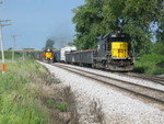 Eastbound coal empties pass the setout engine and cars for the Wilton local, at the east end of N. Star siding, Aug. 13, 2007.