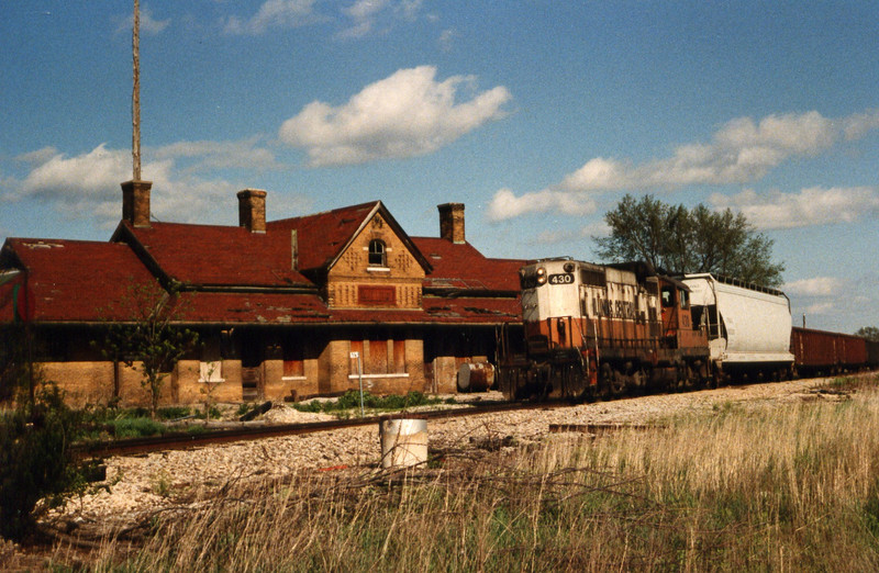 The Wilton local, 430 west, passes a rundown West Liberty depot, April 1990