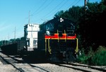 250 with a transformer and a string of several gons in tow heads east back when the Wilton turn came out of Iowa City. 03-August-1987.