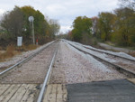 Looking east, in the middle of Grinnell siding, mp 302.  The signal is the westbound approach to Grinnell interlocking.  Oct. 24, 2005.