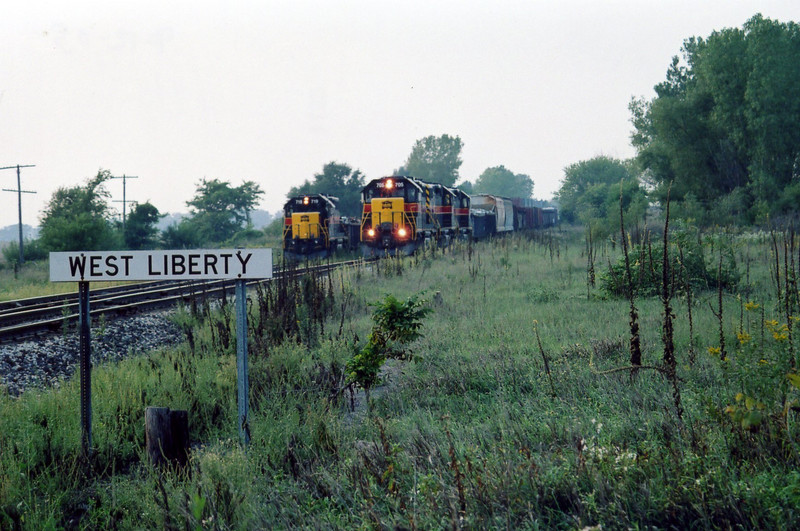 Eastbound at West Liberty and eng. 719 on the local, in the siding.  Sept. 12, 2005.