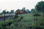 Eastbound at West Liberty and eng. 719 on the local, in the siding.  Sept. 12, 2005.