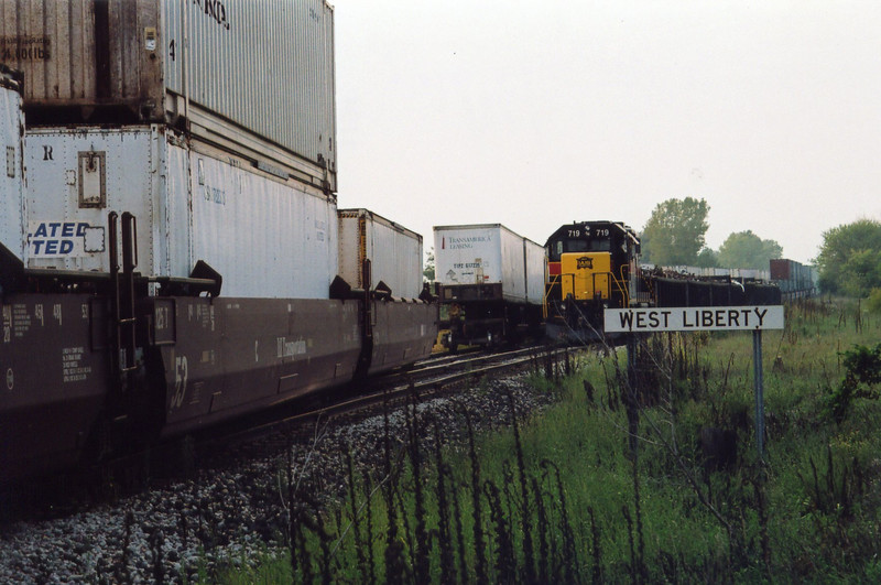 Eastbound picking up pigs at West Lib. siding, while the local waits on the main.  Sept. 12, 2005.